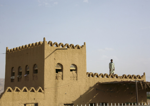 Man standing on a multi-storey building terrace, Marib Governorate, Marib, Yemen