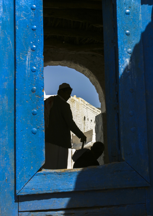 Yemeni men going inside the white Mosque of Ahmed Ibn Alwan, Taiz Governorate, Yafrus, Yemen