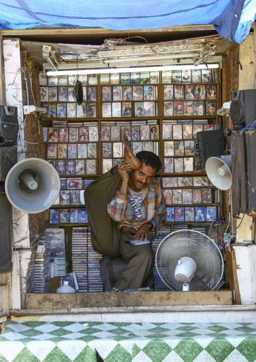 Yemeni music seller making fool in his little shop, Taiz Governorate, Mokha, Yemen