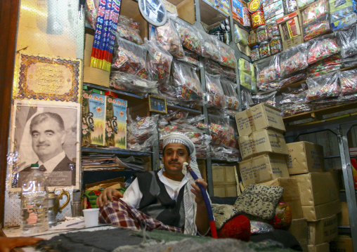 Yemeni man in ashop with Rafik Harari portrait, Amanat Al-Asemah, Sanaa, Yemen