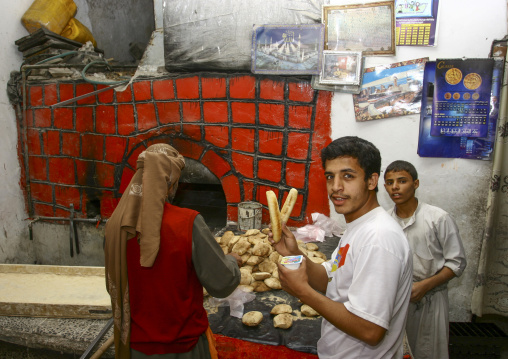 Baker working in front of his oven, Amanat Al-Asemah, Sanaa, Yemen