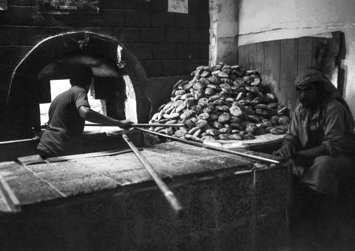 Baker working in front of his oven, Amanat Al-Asemah, Sanaa, Yemen