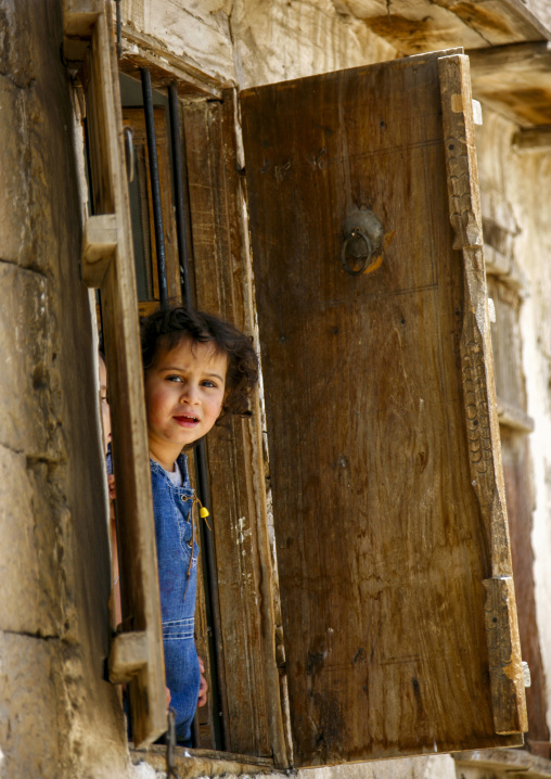 Portrait of a yemeni girl at a window, Amanat Al-Asemah, Sanaa, Yemen
