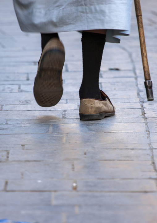 Rear view of man wlaking with a cane, Amanat Al-Asemah, Sanaa, Yemen