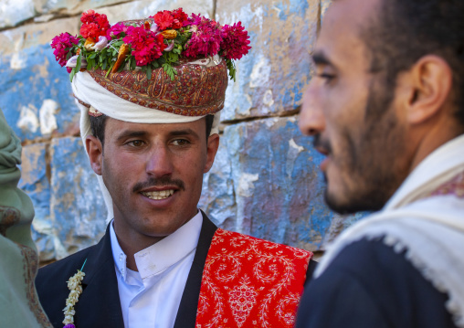 Grooms with turbans decorated with flowers during a wedding, Amran Governorate, Thula, Yemen