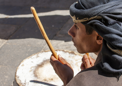 Yemeni man playing drum during a wedding, Amran Governorate, Thula, Yemen