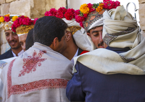 Grooms with turbans decorated with flowers during a wedding, Amran Governorate, Thula, Yemen