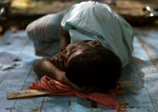 Man Wearing A Mustache Sleeping On The Ground At Madurai Market, India