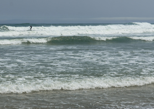 Japanese surfer in the contaminated area after the daiichi nuclear power plant irradiation, Fukushima prefecture, Tairatoyoma beach, Japan