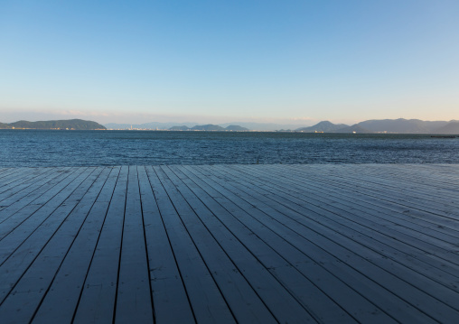 Wooden terrace beside tropical sea in Benesse house hotel, Seto Inland Sea, Naoshima, Japan