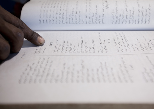 Forefinger of a witchdoctor reading jinn book, Lamu County, Lamu, Kenya