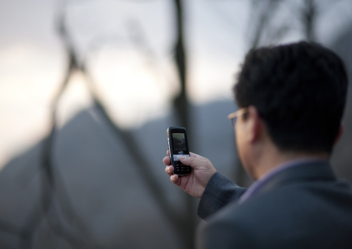 North Korean man taking pictures with his mobile phone
, Kangwon Province, Wonsan, North Korea